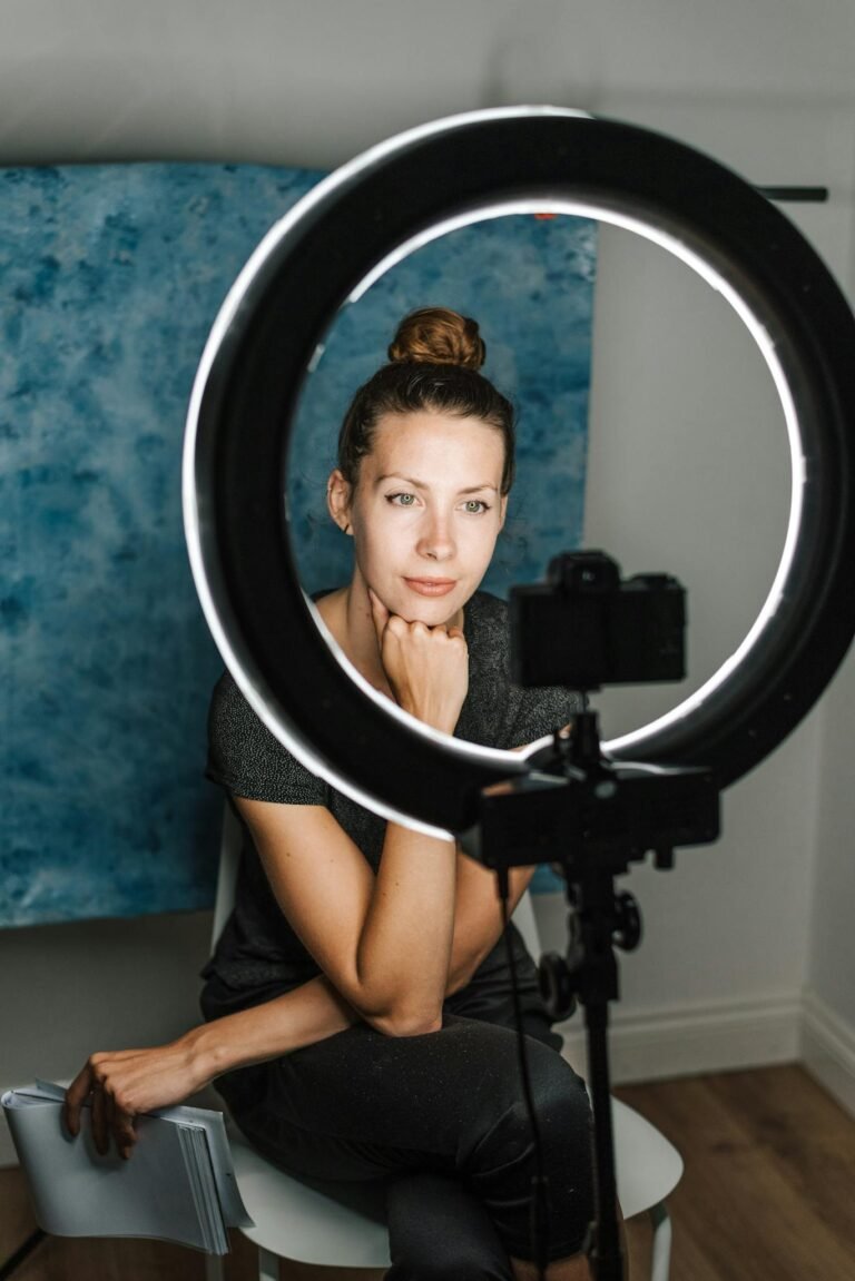 Young woman taking self portrait in modern studio